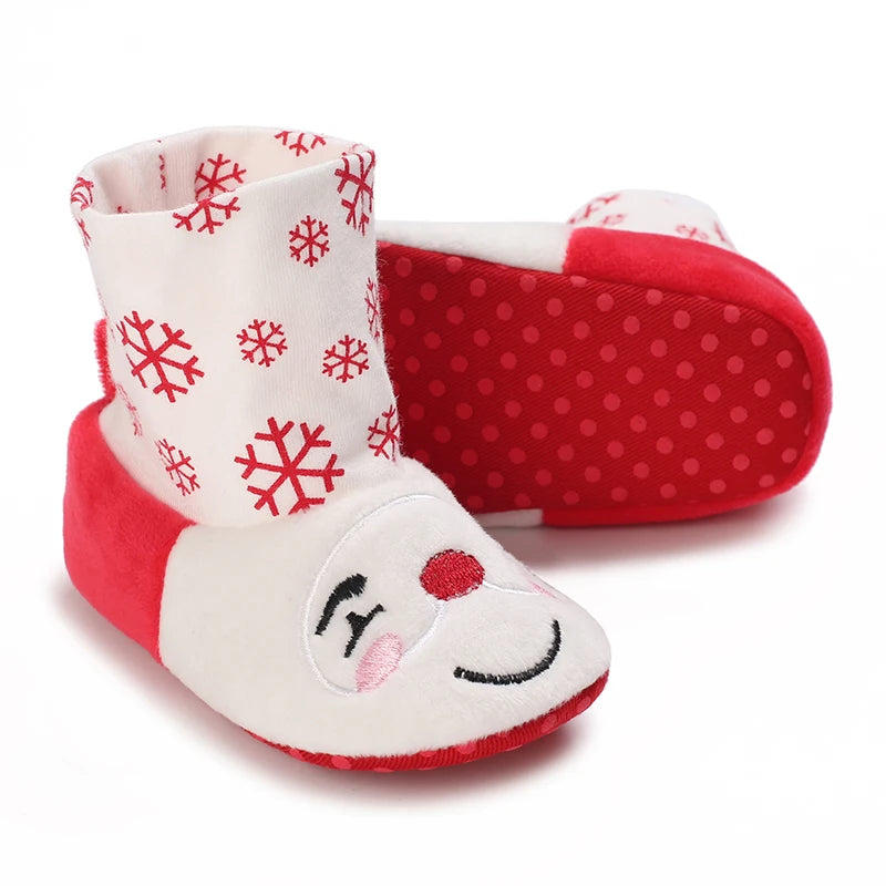 A pair of red and white baby winter boots featuring a festive snowflake pattern on the cuff.