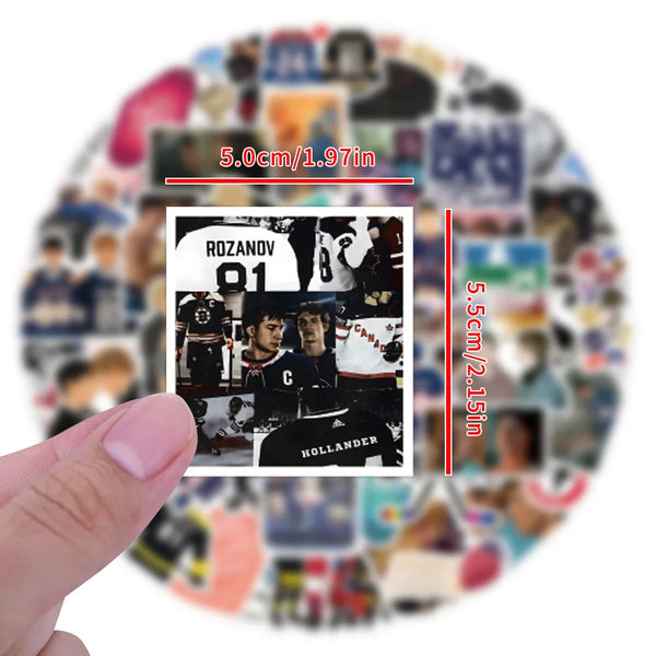 A hand holds a square sticker featuring a sports player and the number 01, surrounded by various other stickers.