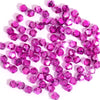 A collection of small, faceted pink and magenta crystal glass beads for jewelry making