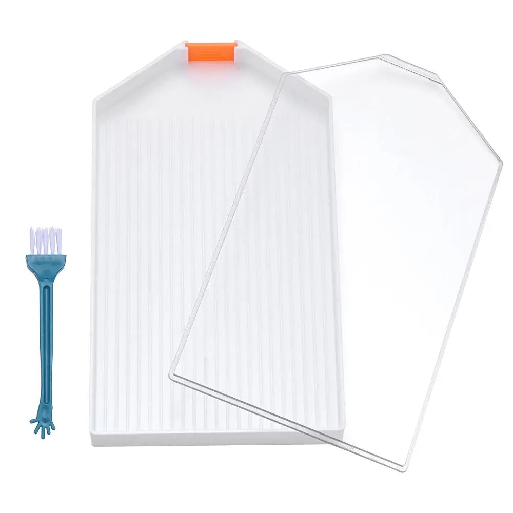 A white large diamond painting tray with a clear pop-up plug and a blue plastic tool for bead sorting.