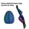 A teal and purple dragon egg fidget spinner with a silky texture.