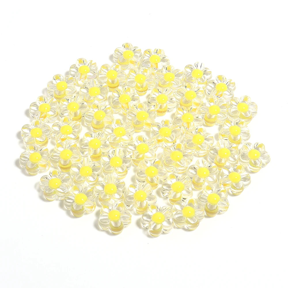 A pile of small, colorful transparent acrylic flower beads for DIY jewelry making.