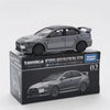 A Tomica Mitsubishi Lancer Evolution final edition die-cast model car in silver on a black box.