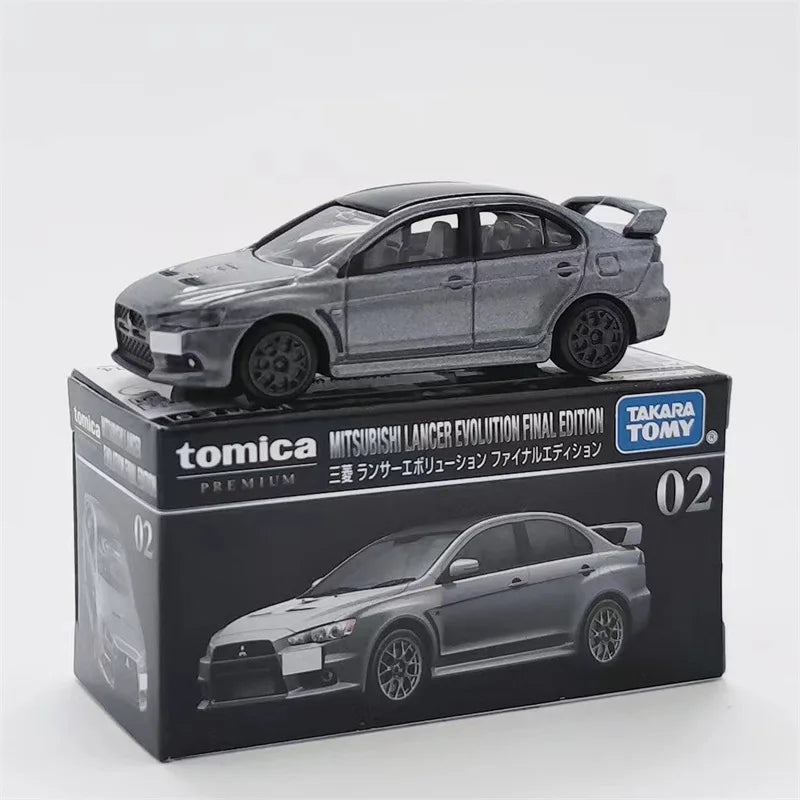 A Tomica Mitsubishi Lancer Evolution final edition die-cast model car in silver on a black box.