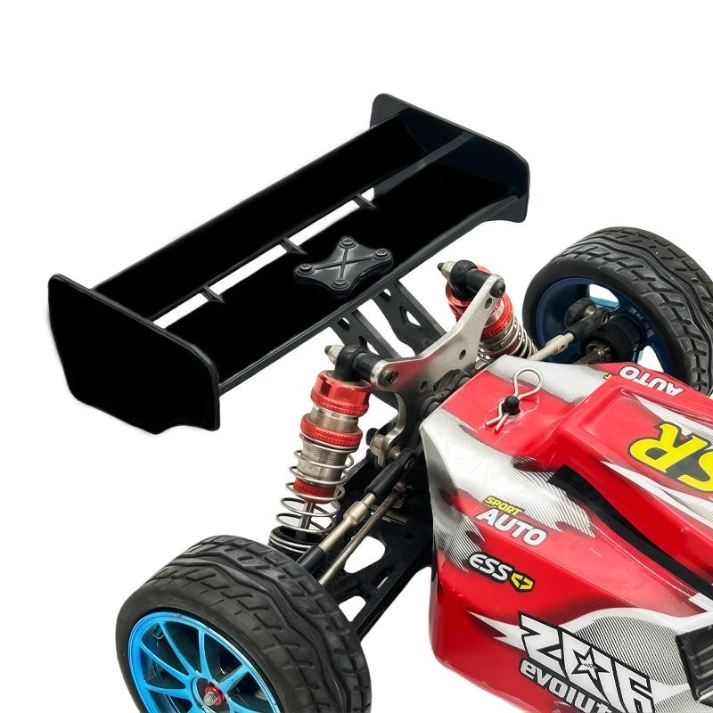 A red and black hard tail wing upgrade for an RC car, featuring a tire and mounting hardware.