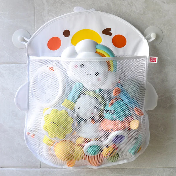 A white mesh bag filled with various cartoon duck bath toys and floating sun shapes.