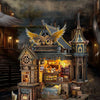 A detailed wooden miniature kit of an illuminated owl post office with furniture and puzzle elements.