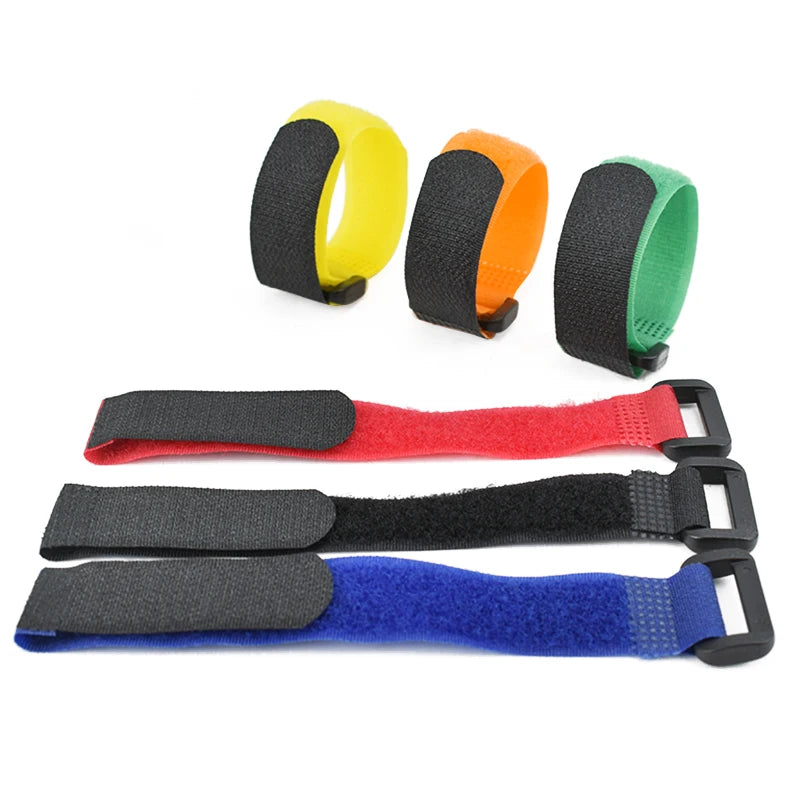 A set of five nylon bike handlebar straps in yellow, orange, black, and green colors.