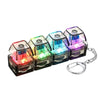 A set of illuminated stress-relief keychain toys with keyboard buttons in various colors.