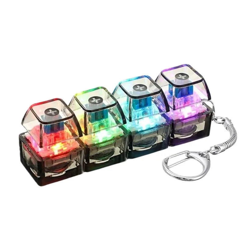 A set of illuminated stress-relief keychain toys with keyboard buttons in various colors.