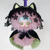 A black and pink plush doll with cat ears and a frilly hood, featuring light blue skin and green eyes.