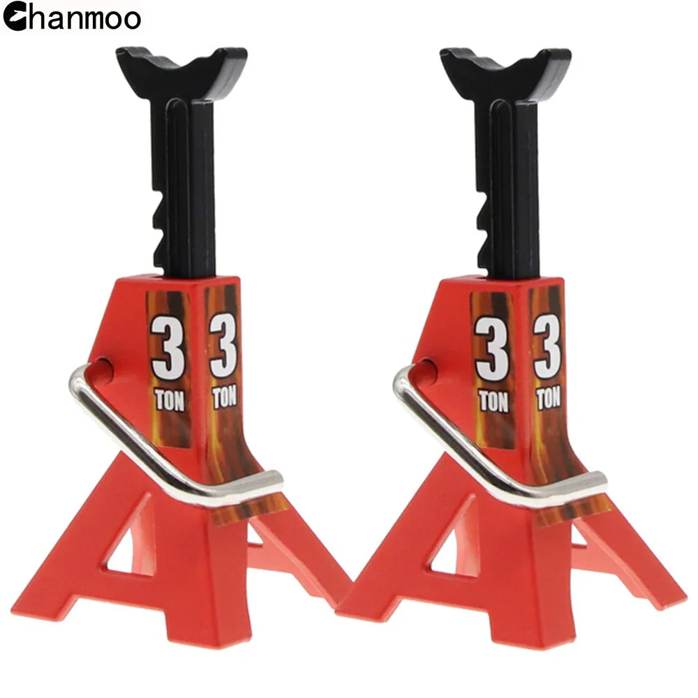 A pair of red metal simulation jack stands with '3 TON' markings for RC crawlers