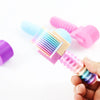 A hand holds a colorful detachable diamond painting roller with various colored cylinders.