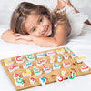 A wooden puzzle set of the Arabic alphabet letters scattered on a light wooden board.