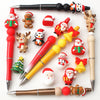 A collection of silicone beads shaped like Santa, reindeer, and Christmas trees used for festive craft jewelry charms.