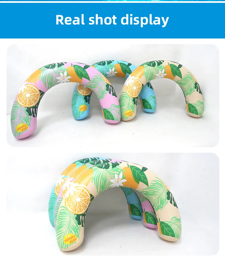 A colorful U-shaped inflatable swim ring with a leafy tropical pattern is shown in various shades of green, pink, and yellow.