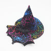 A black witch hat with neon geometric patterns and a black fabric bow.