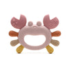 A pink silicone crab-shaped baby teether with soft, rounded features and small stars on the claws.