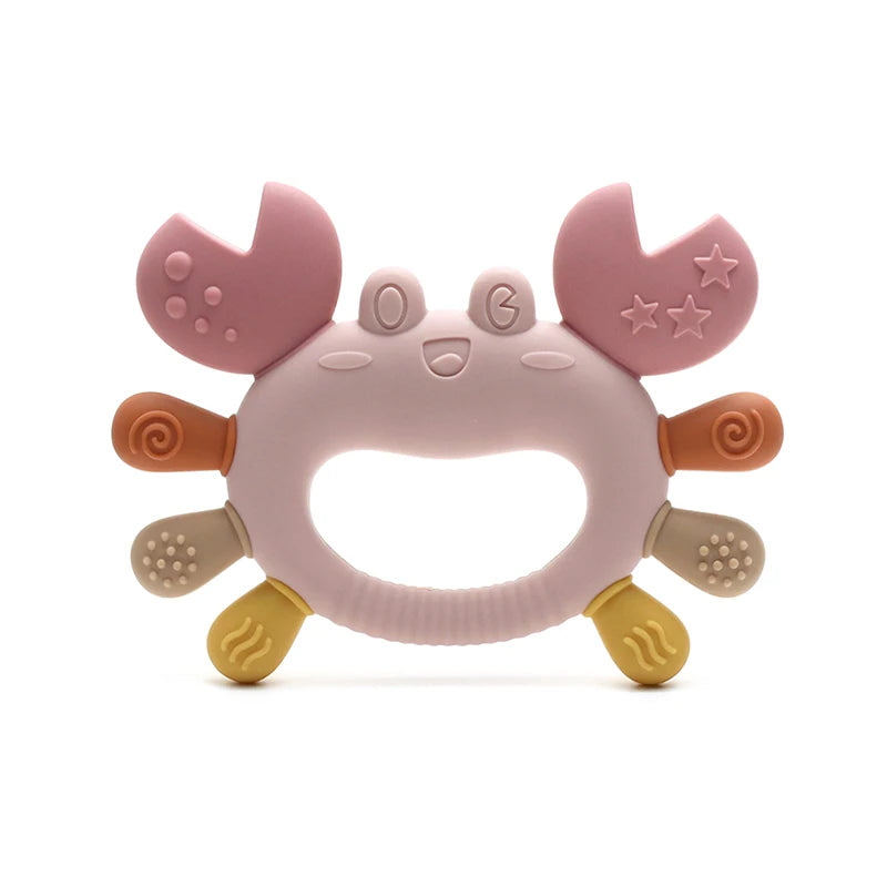 A pink silicone crab-shaped baby teether with soft, rounded features and small stars on the claws.
