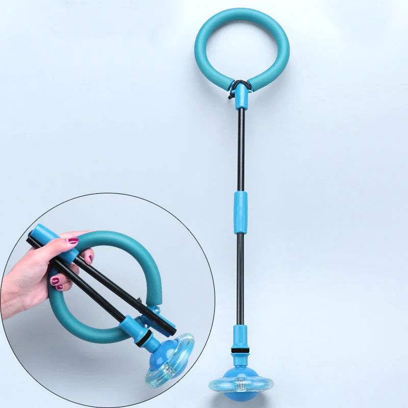 A teal glowing ankle skip ball with a black handle and flashing LED light, shown next to a hand.