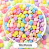 A bowl filled with pastel bear-shaped acrylic craft beads in various shades of pink, yellow, blue, and purple.