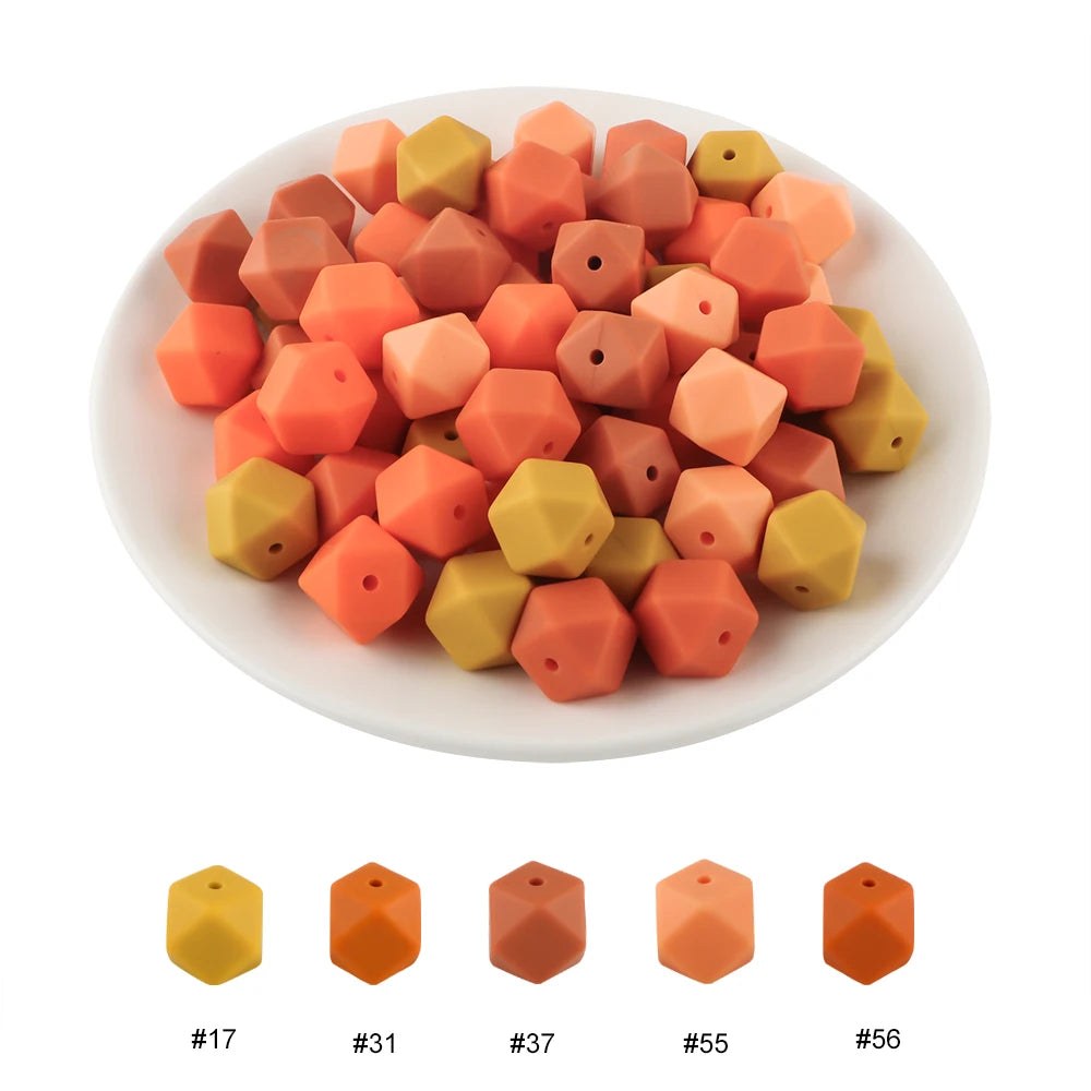 A pile of 15 hexagonal silicone beads in various shades of orange and yellow.
