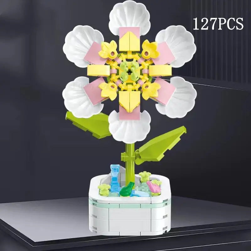 A set of 127 plastic rose flower building blocks in various colors arranged on a white base.