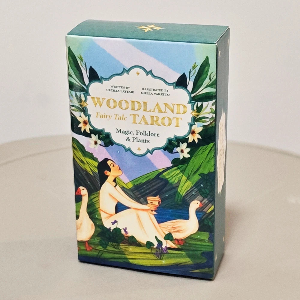 A box for the Woodland Fairy Tale Tarot deck featuring illustrations of a woman and a goose on a green landscape.