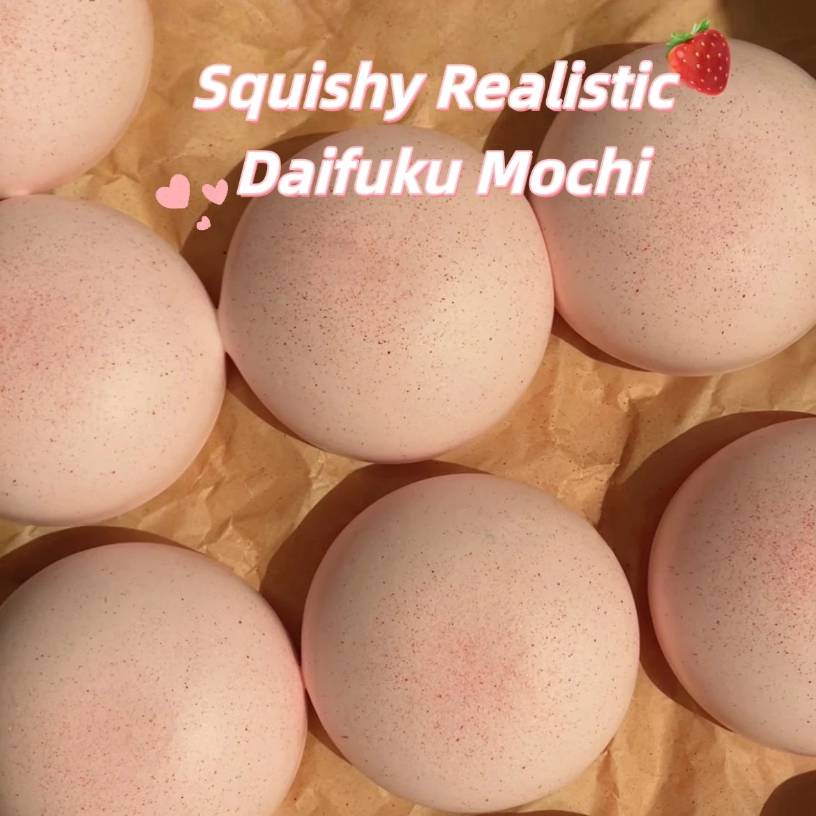 Pink squishy realistic daifuku mochi toys resting on brown paper