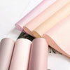 A stack of pink and beige translucent tissue paper sheets for gift wrapping and flower bouquets.