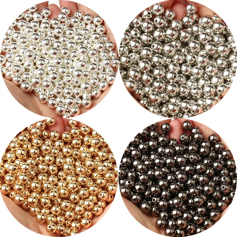 A collection of round spacer beads in various metallic colors including silver, gold, and black.