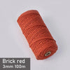 A spool of brick red 3mm cotton macrame cord measuring 100 meters.