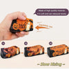 A hand holds an orange Halloween-themed squishy stress toy, demonstrating its soft and slow rebound texture.