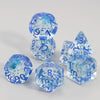 A collection of clear blue glitter polyhedral dice including a D4, D6, D8, D10, D12, and D20, scattered on a white surface.