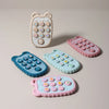 A collection of phone-shaped silicone teethers in various pastel colors and designs for babies.