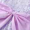 A lilac floral print dress featuring a pink bow detail and gathered fabric.