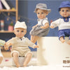 A lifelike 14-inch reborn baby doll with a voice and fashion outfit, shown in a studio setting.