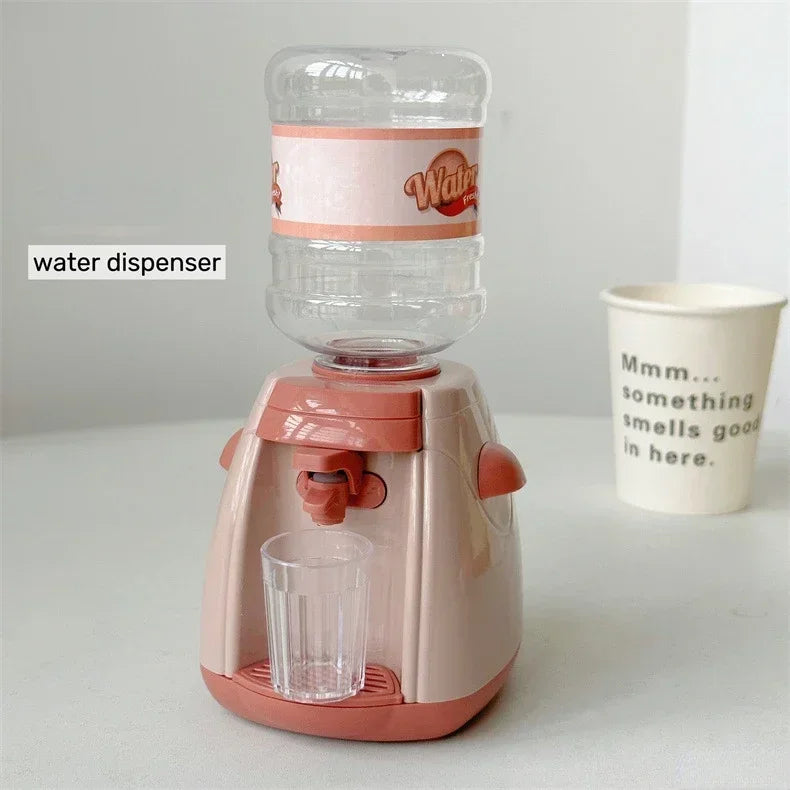 A pink water dispenser device with a glass cup is shown on a white surface.