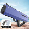 A purple high-pressure electric water gun is shown with its charging set on a sandy surface.