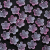 A collection of 50 glass cherry blossom flowers in various shades of purple and pink for jewelry making