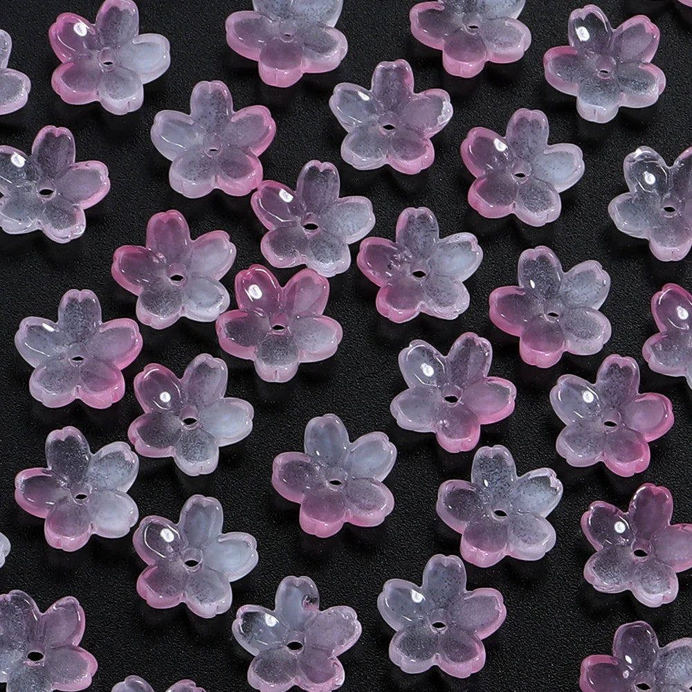 A collection of 50 glass cherry blossom flowers in various shades of purple and pink for jewelry making