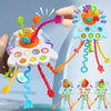 A hand is pulling colorful string toys with various shapes and colors from a white cloud-shaped sensory toy.