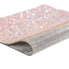 Close-up of iridescent pink sparkling rhinestone adhesive tape rolled up for DIY crafts