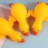 A bright yellow squishy duck fidget toy is shown against a light blue background.
