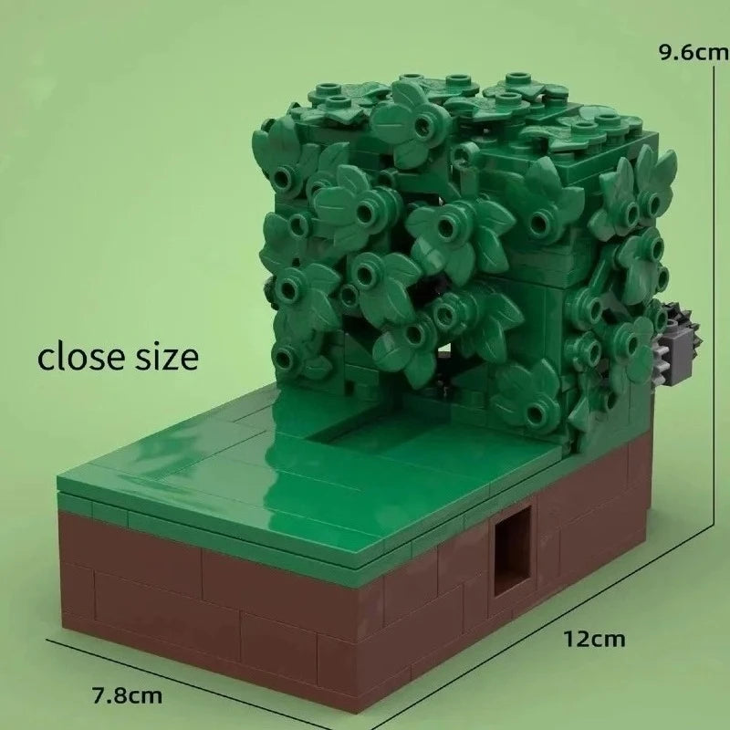 A green MOC building block set depicting a figure in bushes on a brown base.