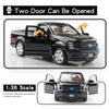 A black 1:36 scale diecast model of a Ford F-150 truck with the doors open.