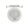 A white silicone baking mold shaped like a seashell, measuring 5.5cm or 2.12in.