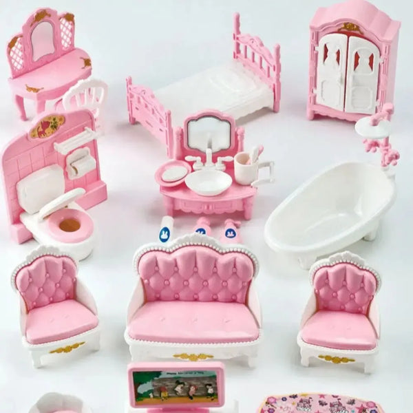 A collection of pink and white miniature dollhouse furniture including a bed, toilet, vanity, and chairs.