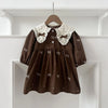 A brown cotton party dress for girls featuring white lace collar and embroidered details, displayed on a hanger.