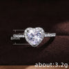 A close-up of a heart-shaped diamond ring with pave accents, measuring 8mm and weighing about 3.2 grams.
